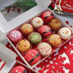 a box filled with cupcakes sitting on top of a red and white table