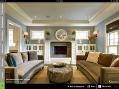 a living room with two couches and a coffee table in front of a fireplace