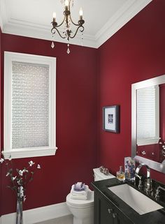 a bathroom with red walls, white trim and black counter tops is featured on pinterest