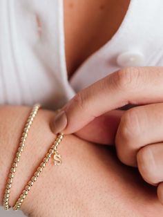 Make your stack personal with an Initial Charm! Wear your own initial, your children's, or a loved one's for a sentimental touch — or gift the heartwarming piece to someone you love. Designed with durability in mind, our gold-fill beads and charms are secured on extra-strength stretch cord to withstand your busy life and maintain their shine. Whether you dress them up, dress them down, or pile them on, you’ll truly never take them off. Classic Letter Beads Jewelry As Gift, Classic Letter Beads Jewelry Gift, Classic Personalized Beaded Bracelets As Gift, Classic Initials Bracelet, Perfect As Gift, Classic Personalized Beaded Bracelets For Gifts, Classic Hypoallergenic Bracelets As Personalized Gift, Classic Hypoallergenic Bracelets For Personalized Gifts, Everyday Jubilee Bracelet, Dainty Bracelets With Initials For Personalized Gifts