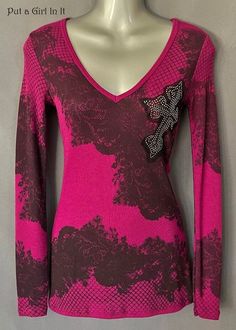 New Womens Vocal Apparel embellished magenta pink cross long sleeve shirt This incredibly unique Vocal shirt is just stunning. Gorgeous magenta pink cross embellished top. Colorful pink and clear embellished crystals overlaying black lace contrast. SO MUCH BLING! Runs Small - please see measurements. You won't find this top ANYWHERE else, discontinued by Vocal. Just GORGEOUS Made in USA by Vocal Apparel I have been selling Vocal clothing for 15 YEARS now and just LOVE this brand! Please see measurements 63% Polyester - 34% Rayon - 3% Spandex Has very little stretch in material Measured without stretching - Juniors Fit - Please compare measurements to a top you have and love at home *Small - measures 13.5" armpit to armpit - shoulder to hem 27" *Medium - measures 14.5" armpit to armpit - sh Pink Cross, Black Cross, Magenta Pink, Fashion 2024, Embellished Top, Virtual Closet, Fancy Dresses, Dream Wardrobe, Pink Black