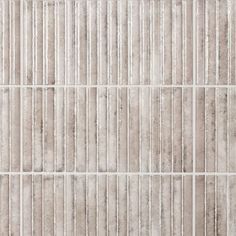 a white tile wall with vertical lines on it