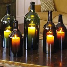 a table topped with bottles filled with candles