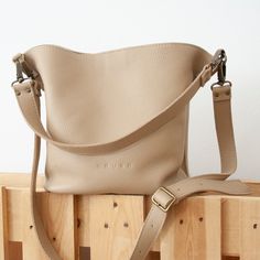 "We have designed our simple, practical and functional MAE bag, following the latest trends. This bucket leather bag is a classic that never goes out of style and will become more than just an accessory for you. It is handmade with all the care and experience of our craftsmen, always using natural leathers that improve over the years. The MAE bag is made of full grain leather, a thick grain leather of the highest quality and 100% European origin. It has an interior pocket with zipper to store yo Backpack Purses, Crocs Outfit, Bags Inside, Mother Days, Wallet Cute, Purse Essentials, Bucket Purse, Free Tote, Bags Handmade