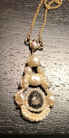 "A Georgian natural pearl and rose cut diamond 14k wedding necklace.  Condition for its age is very good, a later 14K wire frame was custom designed to protect this antique treasure-the chain is also later added and is stamped 14K.  The Georgians loved pearls and it was a favorite for weddings.  The pearls are mounted on the period mother of pearl backing, the unusual rose cut Diamond is tear  shaped(5mm by 4mm) and set in silver-early rare shape & faceting to the diamond.  Chain is 17\", centra Antique Wedding Necklaces With Jewels, Antique Rose Cut Diamond Wedding Necklaces, Victorian Pearl Drop Necklace For Formal Occasions, Victorian Style Pearl Pendant Necklace, Vintage Pendant Necklace With Rose Cut Diamonds, Vintage Rose Cut Diamond Pendant Necklaces, Victorian Pearl Necklace For Formal Occasions, Antique Pearl Pendant Necklace For Formal Occasions, Formal Antique Pearl Drop Necklace