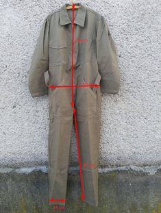 "Absolutely fantastic unused vintage Swiss army light brown-green coverall jumpsuit. Good military uniform of high quality materials and in excellent condition. Suitable for both fashionable upgrades or for work wear). MOD. DEP Please see detailed measurements below to ensure the desired fit. If you have any questions regarding the size or state of a particular combination, please contact. CONDITION: NEW unused condition, detail in the photo. MEASUREMENTS: Size 50 Shoulders: 49cm (19.3\") Arm Le Khaki Cotton Long Sleeve Jumpsuits And Rompers, Military Style Khaki Jumpsuit, Military Style Green Overalls With Pockets, Military Green Overalls With Pockets, Vintage Green Cotton Jumpsuits And Rompers, Khaki Military Style Long Sleeve Jumpsuits, Military Style Long Sleeve Khaki Jumpsuit, Khaki Military Long Sleeve Jumpsuit, Khaki Long Sleeve Utility Overalls