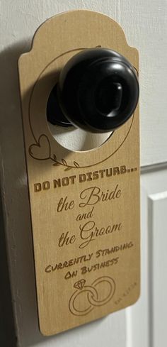 a door handle that is attached to the side of a door with a wedding ring on it