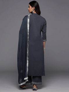 Grab this beautiful 3-piece set. The set comes with gota embroidered straight shape kurta has mandarin collar, 3/4th flared sleeves & calf length teamed with solid trouser pant with slip on closure & elasticated waistband and a dupatta. Color - Grey Kurta Fabric-Cotton Blend Pant Fabric-Cotton Blend Dupatta Fabric - Silk Chiffon Neck-Mandarin Collar Sleeves-3/4th Sleeves Work - Gota Embroidery Detailing Washing Instructions-Dry Clean DISCLAIMER - The color of the product may be differ due to scr Elegant Cotton Anarkali Set With Gota Work, Elegant Cotton Sharara With Gota Work, Elegant Sharara With Embroidered Border And Straight Kurta, Elegant Georgette Palazzo Set With Embroidered Border, Elegant Cotton Sharara With Embroidered Border, Elegant Cotton Sharara For Navratri, Elegant Kurta With 3/4 Sleeve For Eid, Elegant Kurta With 3/4 Sleeves For Festive Occasions, Elegant 3/4 Sleeve Kurta For Eid