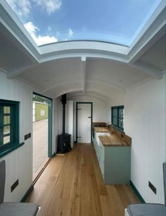 the interior of a tiny house with wood floors and skylight above it, as seen from inside