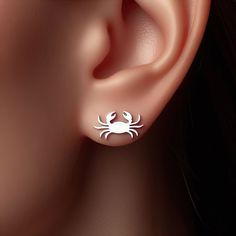 Width: 15mm Dive into coastal charm with these captivating Crab Earrings! 🦀✨ A symbol of protection and transformation, these earrings are perfect for beach lovers and those who are drawn to the mystery of the ocean. Crafted in sterling silver, solid 14k yellow gold, rose gold, or white gold, these minimalist crab earrings are a delicate and enchanting addition to your jewelry collection. Ideal for a day by the sea or as a reminder of oceanic wonders, these earrings bring a touch of marine magic to your look. These Crab Earrings are more than just accessories; they're a tribute to the fascinating creatures of the deep and the allure of the seaside. Perfect as a gift for a marine life enthusiast or as an elegant expression of your love for the sea, these earrings are sure to delight. Let t Crab Jewelry, Crab Earrings, Nose Piercing, Crab, Jewelry Earrings Studs, Silver Earrings, Gold Jewelry, Jewelry Collection, Etsy Earrings