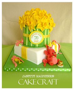 a green cake with yellow flowers on top