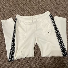 White Nike Track Pants. Size Small And Can Definitely Fit A Medium. Fits A 27-30. Nwot. White And Black Color. Worn Once Nike Fitted White Bottoms, Nike White Fitted Bottoms, Nike Casual White Pants, White Fitted Nike Bottoms, Sporty White Trousers, Nike White Sweatpants For Spring, Nike White Pants For Spring, Nike Sporty White Pants, White Fitted Sporty Sweatpants