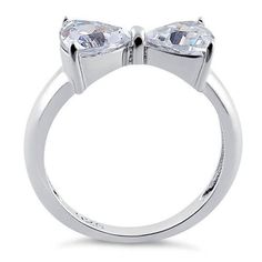 Top of ring height: 7.2mm Top of ring width: 14.8mm Band width: 4mm Shank width: 2.6mm Stone material: clear cubic zirconia Stone shape: heart cut Total number of CZ stones: 2 Stone setting: prong setting Metal: 925 sterling silver Plating: rhodium plated Finish: high polish Bow Ring, Stone Material, Silver Bow, Stone Setting, Cz Ring, Sterling Silver Heart, Cz Stone, Real Diamonds, Stone Settings