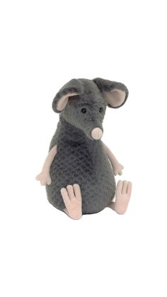 a stuffed animal mouse sitting on the ground