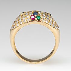 This posh ring is accented with sixty-eight (68), bead set, round brilliant cut diamonds, three (3), shared prong set, round mixed cut natural blue sapphires, three (3), shared prong set, round mixed cut natural emeralds and three (3), shared prong set, round mixed cut natural rubies. The ring measures 10.8mm at the top, rises 4.9mm above the finger, tapering to 4.2mm wide and 1.1mm thick at the base of the shank. This ring is currently a size 7. Luxury Multi-stone Cubic Zirconia Diamond Ring, Luxury Cubic Zirconia Multi-stone Diamond Ring, Luxury Multi-stone Diamond Cluster Ring, Luxury Multi-stone Cluster Diamond Ring, Fine Jewelry Multi-stone Round Cut Diamond Ring, Luxury Multi-stone Cubic Zirconia Cluster Ring, Elegant Multi-stone Cluster Ring In Round Cut, Luxury Multi-stone Round Cut Diamond Ring, Elegant Multi-stone Cluster Ring