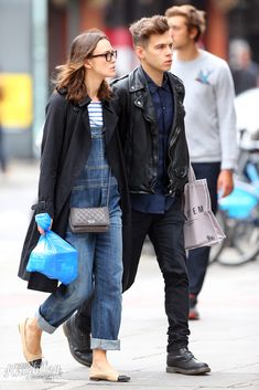 a man and woman walking down the street