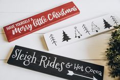 three wooden signs with christmas trees on them