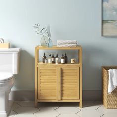 a bathroom with a wooden cabinet next to a toilet