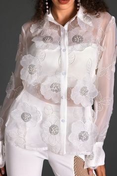 Step into a world of style with our organza embroider floral shirt. This shirt boasts intricate floral embroidery on delicate organza fabric, exuding modern elegance and charm. The addition of transparent elements adds a subtle allure, ensuring you radiate charm and confidence at every event. Handmade customization Fabric composition: 90% polyester fiber, 10% spandex Washing method: hand wash or dry clean Popular elements: organza Elegant Summer Organza Tops, Feminine Organza Tops For Spring, Summer Long Sleeve Organza Top, Feminine Long Sleeve Organza Tops, Long Sleeve Organza Top For Summer, Elegant Spring Wedding Blouse, Long Sleeve Top With Floral Embroidery For Weddings, Spring Formal Organza Tops, White Organza Evening Top