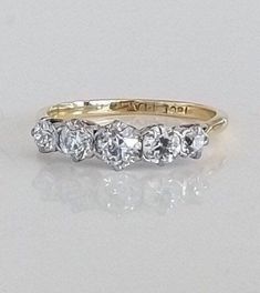 three stone diamond ring in yellow gold