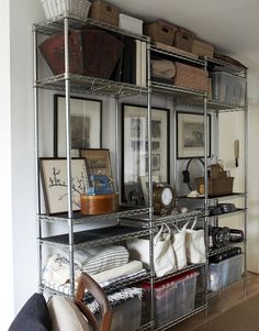 the shelves are organized with baskets and other items