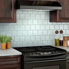 a black stove top oven sitting in a kitchen next to wooden cabinets and counter tops