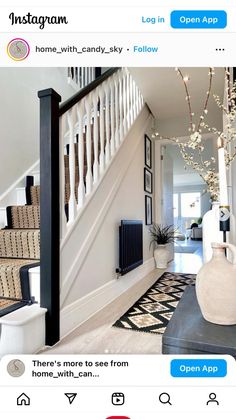 an entry way with stairs and vases on the floor