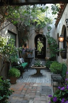 an outdoor courtyard with potted plants and chairs