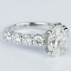 an oval cut diamond ring with side stones