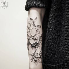 a woman's arm with flowers on it