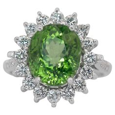 Gorgeous 8.08ct Peridot and Diamonds Cluster Ring in 14k White Gold - IGI Certified This stunning 14k white gold cluster ring features a vibrant 7.00-carat oval-cut peridot as the centerpiece, radiating a lush green hue. Surrounding the main stone, 16 dazzling round diamonds with 0.93-carat in total enhance the ring's brilliance, while 10 additional round diamonds totaling 0.15-carat add an extra layer of sparkle. This IGI-certified cluster ring is a unique and luxurious statement piece! Metal: Eternity Ring Gold, Green Side, Peridot Stone, Sparkling Rings, Modern Ring, Eternity Ring Diamond, 14k White Gold Ring, Diamond Cluster Ring, Diamond Eternity