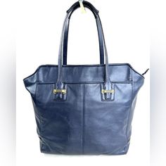 Navy Blue!! Who Doesn't Need More Of This Perfect Neutral In Their Wardrobe? This Coach Taylor F25941 Navy Blue Leather North South Large Tote Shoulder Bag Has Brass Hardware Which Gives It Even More Of Luxe Look. The Front Has A Large Slip Pocket That Any Size Phone Will Fit In. The Back Has The Same Pocket. Inside Is A Zipped Pocket And 2 Slip Pockets. Very Good Condition. Minimal Normal Wear. Wear On Base Of Each Strap (See Pics). The Straps Are Still Very Functional. This Is A Pre-Owned Item Classic Blue Bags For Daily Use, Navy Leather Shoulder Bag For Travel, Blue Satchel Bag For Business, Blue Business Satchel Bag, Coach Shoulder Bag For Office With Large Capacity, Blue Rectangular Shoulder Bag For Business, Blue Crossbody Bag For Business, Elegant Navy Satchel For Everyday Use, Blue Soft Leather Satchel For Office