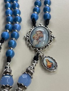 Handmade Blue rosary, sacred heart of Jesus charm ornate crucifix,  blue faceted semi precious Pater beads  8mm blue wooden beads,  Catholic gift  Catholic gift Communion gift  Catholic mom gift God parent gift Handmade Rosary, blue rosary, large rosary, Sacred Heart of Jesus charm, wooden rosary, ornate crucifix, 8mmblue wooden beads, Catholic gift These rosaries are beautiful and would make a wonderful First Communion/Reconciliation or Confirmation gift, wedding gift, or RCIA PSR gift.  The colors are vibrant and gorgeous!   The silver  ornate crucifix is Made in Italy  Blue Miraculous Medal centerpiece is colorful and beautifully detailed.   The rosary measures approximately 22 inches In Length and the crucifix is 2 inches long.   The rosary is made with a very durable No. 9 bonded nylo Spiritual Blue Rosary With 108 Beads, Blue 108 Beads Spiritual Rosary, Blue Rosary With 8mm Beads And Crucifix, Handmade Blue Rosary For Jewelry Making, Blue Cross Rosary For Gift, Blue Cross Rosary As Gift, Blue Rosary With 8mm Beads In Cross Shape, Adjustable Blue Rosary With 8mm Beads, Handmade Blue Rosary With Cross