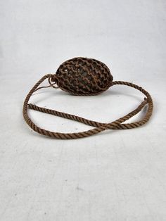 a rope wrapped around an object on a white surface