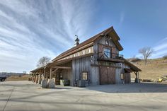 a large wooden building sitting on the side of a road