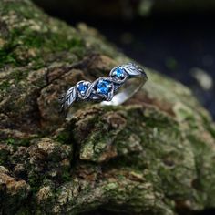 Handmade from sterling silver, our Medieval Aquamarine Nature Inspired Ring exudes vintage charm and ethereal beauty. Adorned with a Celtic branch and knot pattern, this unique piece features a fantasy braided branch with a leaf wedding band. Perfect for Valentine's Day or as a unique fantasy ring, this silver jewelry captures the essence of the Nenya ring forest with its rustic tree ring aesthetic, making it a distinctive and timeless accessory.  Characteristics: Metal - Recycled solid sterling Adjustable Silver Elven Jewelry, Nature-inspired Blue Jewelry For Wedding, Blue Nature-inspired Jewelry For Wedding, Nature-inspired Blue Jewelry For Weddings, Silver Ethereal Jewelry With Birthstone, Silver Birthstone Crystal Ring For Wedding, Silver Crystal Wedding Ring With Birthstone, Mystical Silver Rings For Wedding, Mystical Silver Rings For Weddings