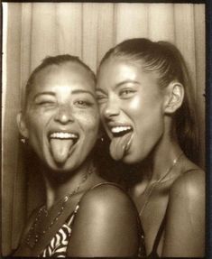 two young women are posing for the camera with their mouths open and one is sticking her tongue out