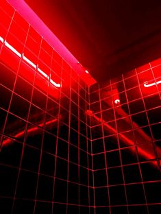 a red light shines in the middle of a tiled wall