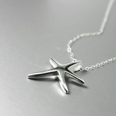 A shiny starfish necklace, handmade in solid sterling silver.  This dancing starfish is 7/8 x 3/4 inches (23x20mm) with a hidden bail for a sleek look.  It hangs from a sterling silver *adjustable* chain of either 16 to 18 inches, or 18 to 20 inches.  Great for layering or wearing alone The mannequin is Life Size so you can see the scale of the pendant. Jewelry Ocean, Sea Life Jewelry, Silver Sea, Starfish Necklace, Ocean Lover, Sleek Look, Necklace Handmade, Life Size, Sea Life