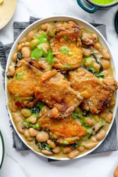 a white bowl filled with chicken and beans