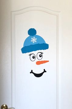 a door with a snowman painted on it's side and a hat on top