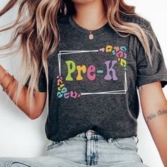 Whether you're looking for a fun and unique gift for a teacher friend or want to treat yourself to something special for the first day of school, this Pre-K Teacher shirt is sure to bring a smile to your face and to your students'. Find more back to school shirts, sweatshirts and gifts for your favorite Pre K teacher here: https://www.etsy.com/shop/JaxGraphicTees?search_query=pre-k All of our adult t-shirts are Bella + Canvas 3001 Unisex shirts. They are a super soft fabric that will quickly become a go to in your wardrobe. Its lightweight and flexible material is perfect for casual wear or any activity. Sizing details: * All shirts are unisex sizing, please refer to the size chart in the listing photographs to determine your size. * If you are not sure what size to order, you can measure Trendy Multicolor School Shirt, Fun Multicolor Shirt For End Of School Year, Multicolor Tops With Name Print For School Spirit, Customizable Casual T-shirt For Back To School, Multicolor Custom Print School Tops, Multicolor Custom Print Tops For School, Multicolor Short Sleeve Tops For Back To School, Customizable Multicolor T-shirt For School, Fun School Tops With Custom Print