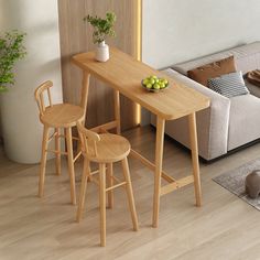 a living room with a couch, table and two stools in front of it