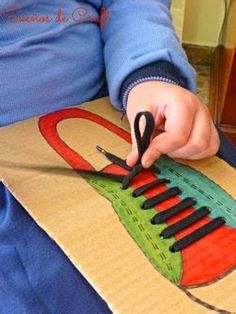 a child is cutting out a piece of paper that looks like a musical instrument with scissors