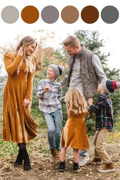 a family walking through the woods with their hands in each other's pockets and holding hands