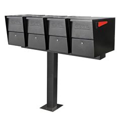 three black mailboxes on a metal post with red light at the top and bottom