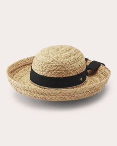 Handcrafted from braided raffia, this classic fedora features a unique brim that can be worn turned up or slanted downward. The ribbon trim is decorated with a goldtone seed logo for luxury appeal. Rounded crown Turn-up brim Ribbon trim with bow Logo detail Outer: 100% braided raffia Trim: 100% cotton Spot clean Materials sourced from Madagascar Made in Sri Lanka Seed Logo, Bow Logo, Helen Kaminski, Cleaning Materials, Ribbon Trim, Personal Shopping, Madagascar, Sri Lanka, Black Cotton