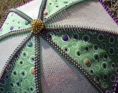 an umbrella is decorated with beads on it