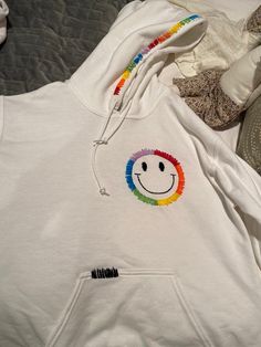 Hand embroidered rainbow smiley face hoodie!! Trendy Embroidered Hooded Hoodie, Fun Cotton Hoodie, Fun Cotton Hooded Hoodie, Rainbow Cotton Sweatshirt For Winter, Trendy Hoodie With Embroidered Logo, Rainbow Casual Winter Hoodie, Casual Winter Rainbow Hoodie, Rainbow Cotton Hoodie, Rainbow Cotton Hooded Hoodie