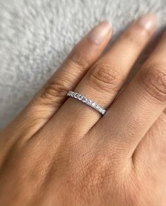 a woman's hand with a diamond ring on it